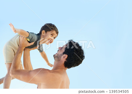 Happy father, beach and lifting boy in bonding, vacation or outdoor holiday weekend together. Dad, child or kid smile for love, support or fun summer break by ocean with blue sky background on mockup 139534505