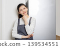 Image of a woman cooking, doing housework, and cooking for herself. 139534551