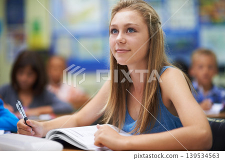 School, girl or thinking with book in classroom lesson for learning, development or education. Studying, scholarship or female learner sitting for exam or test with notes, dream or vision of future 139534563