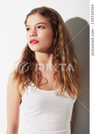 Serious, beauty and young woman in studio with makeup, cosmetic and glamour face. Confident, natural and beautiful female model from Australia with hairstyle for fashion isolated by white background. 139534564