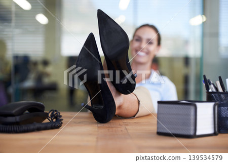 Woman, feet and relax on desk in office with smile, pride and done with goal, relief or fashion at finance agency. Person, employee and happy with shoes on table, finished or achievement in workplace Woman, feet and relax on desk in office with smile, pride and done with goal, relief or fashion at finance agency. Person, employee and happy with shoes on table, finished or achievement in workplace 139534579
