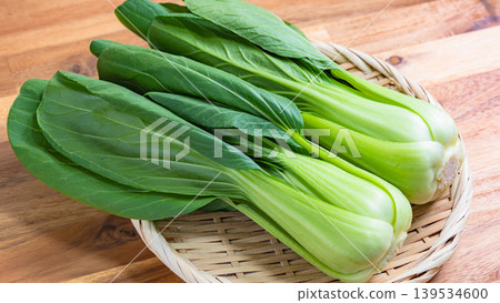 Bok choy, fresh bok choy on a basket, wooden table Bok choy, fresh bok choy on a basket, wooden table 139534600