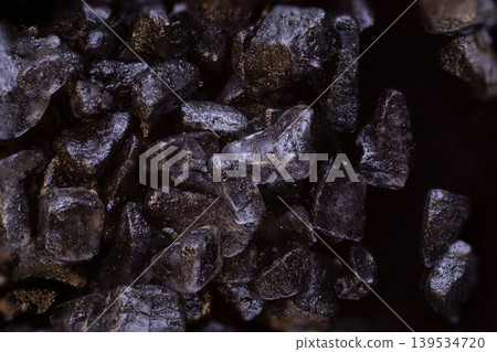 many crystals black hawaiian salt very close on black food background isolated many crystals black hawaiian salt very close on black food background isolated 139534720