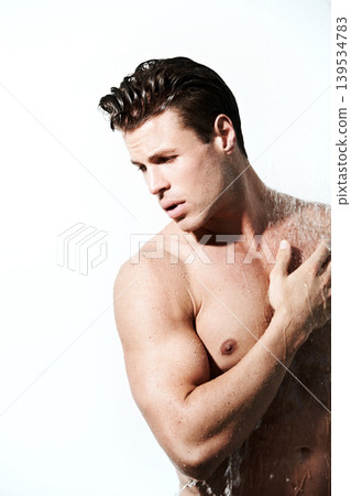 Shower, hot and body of man with water for washing, cleaning and skincare wellness. Young, sexy and muscular male model person with grooming and hygiene for healthy skin by white studio background. Shower, hot and body of man with water for washing, cleaning and skincare wellness. Young, sexy and muscular male model person with grooming and hygiene for healthy skin by white studio background. 139534783