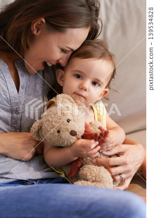 Mother, baby and happy in embrace at home, love and together for bonding in childhood. Mommy, daughter and support for toddler in child development, mama and security or connection and teddy bear 139534828