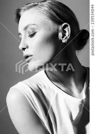 Face of woman, black and white in studio for fashion, retro or classic aesthetic by gray background with light. Isolated model, edgy outfit or clothes with vintage style, lady or pose with cool art 139534844
