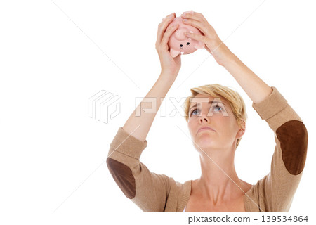 Frustrated woman, piggy bank and financial crisis for debt, mistake or loss on white studio background. Young female person looking in empty money container for coins, cash or finance on mockup space Frustrated woman, piggy bank and financial crisis for debt, mistake or loss on white studio background. Young female person looking in empty money container for coins, cash or finance on mockup space 139534864