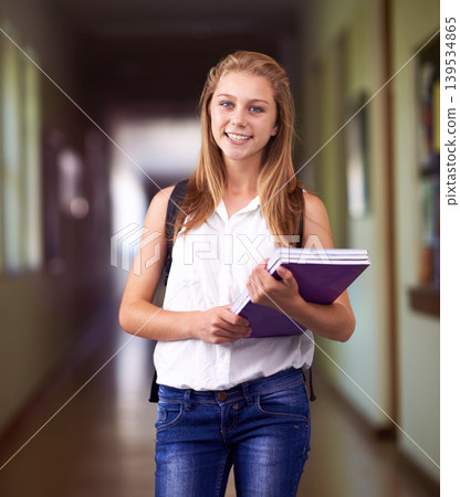 Happy woman, portrait and student with books at school hallway for education, study or learning. Young female person or teenager smile with textbooks or backpack for studying or knowledge in corridor Happy woman, portrait and student with books at school hallway for education, study or learning. Young female person or teenager smile with textbooks or backpack for studying or knowledge in corridor 139534865