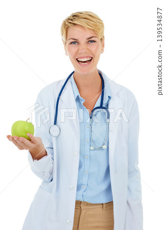 Doctor, woman in portrait and apple for health and diet with nutritionist in studio, smile and wellness on white background. Healthy food, medical professional with fruit for nutrition or weightloss 139534877