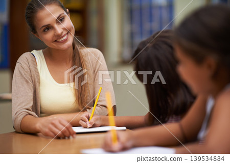Happy teacher, students and writing in class for education, learning or tutoring at school. Woman, mentor or educator smile for helping kids or children with books in study, library or classroom Happy teacher, students and writing in class for education, learning or tutoring at school. Woman, mentor or educator smile for helping kids or children with books in study, library or classroom 139534884