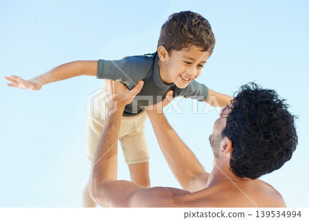 Happy father, beach and lifting child in bonding, vacation or outdoor holiday weekend together. Dad, boy or kid smile for love, support or fun summer break by ocean with blue sky background on mockup 139534994