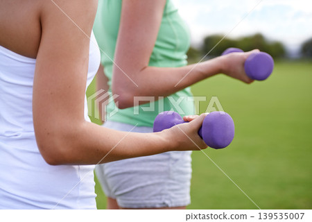 Dumbbell in hands, weightlifting for fitness and muscle, athlete outdoor for sport and bodybuilding. Healthy, exercise equipment and strong people in park, bicep and bodybuilder with workout together Dumbbell in hands, weightlifting for fitness and muscle, athlete outdoor for sport and bodybuilding. Healthy, exercise equipment and strong people in park, bicep and bodybuilder with workout together 139535007