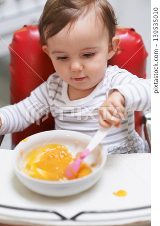 Baby, high chair and bowl for meal, nutrition or healthy porridge with spoon to eat food at home. Young adorable cute little child, kid or toddler playing with snack for hunger, vitamins or nutrients 139535010