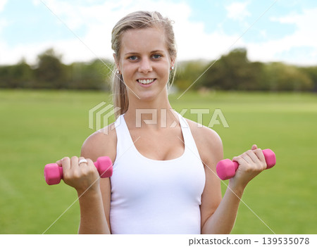 Woman, portrait and dumbbells outdoor for fitness with smile for workout, training or exercise on sports field. Athlete, person and happy for physical activity or healthy body on grass with equipment Woman, portrait and dumbbells outdoor for fitness with smile for workout, training or exercise on sports field. Athlete, person and happy for physical activity or healthy body on grass with equipment 139535078