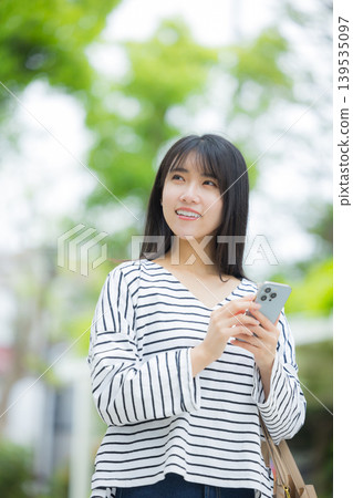 操作智能手機的一個少婦戶外 139535097