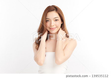 A beautiful young Asian woman with clean, fresh skin against a white background. Skincare, facial treatment, cosmetology, beauty, and spa. An elegant portrait of an Asian woman. A beautiful young Asian woman with clean, fresh skin against a white background. Skincare, facial treatment, cosmetology, beauty, and spa. An elegant portrait of an Asian woman. 139535112