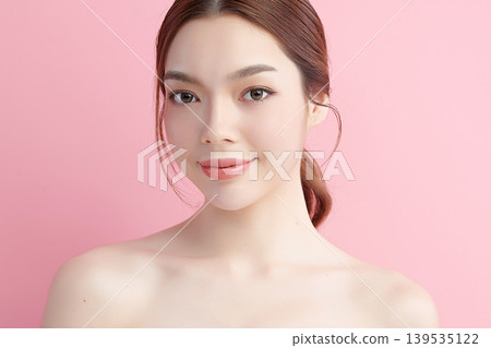 A beautiful young Asian woman with clean, fresh skin against a pink background. Skincare, facial treatment, cosmetology, beauty, and spa. An elegant portrait of an Asian woman. A beautiful young Asian woman with clean, fresh skin against a pink background. Skincare, facial treatment, cosmetology, beauty, and spa. An elegant portrait of an Asian woman. 139535122