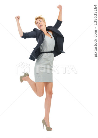 Excited, jump and businesswoman in a studio with success in celebration of goals or winning lottery. News, wow and happy employee with smile, deal or job promotion announcement on white background Excited, jump and businesswoman in a studio with success in celebration of goals or winning lottery. News, wow and happy employee with smile, deal or job promotion announcement on white background 139535164