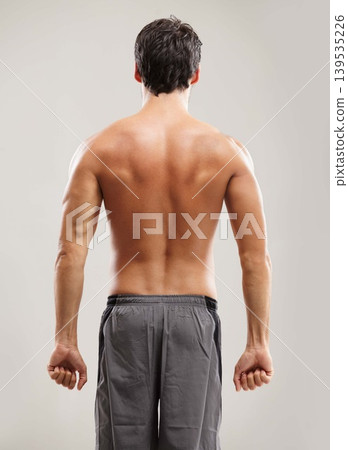 Back, topless or athlete for fitness results, wellness and health isolated on grey background in studio. Muscle, sports man or model with progress in exercise, workout and training on backdrop alone Back, topless or athlete for fitness results, wellness and health isolated on grey background in studio. Muscle, sports man or model with progress in exercise, workout and training on backdrop alone 139535226