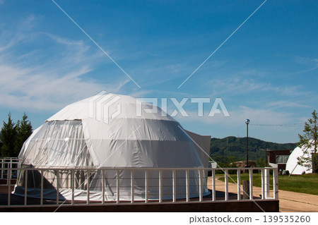 Glamping dome and blue sky illuminated by the morning sun Glamping dome and blue sky illuminated by the morning sun 139535260