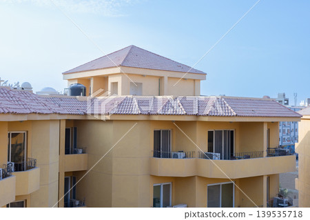 Apartment complex with yellow walls and tiled roofs on October 1, 2023 in Hurghada, Egypt Apartment complex with yellow walls and tiled roofs on October 1, 2023 in Hurghada, Egypt 139535718