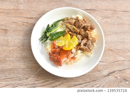 grilled pork with Bulgogi sauce Korean food with kimchi dressing slice yellow pickled radish topping rice on plate grilled pork with Bulgogi sauce Korean food with kimchi dressing slice yellow pickled radish topping rice on plate 139535728