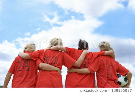 Woman, hug and back of soccer team ready for sports match, game or outdoor practice with blue sky. Rear view of female person or group of football players standing in unity with ball in nature Woman, hug and back of soccer team ready for sports match, game or outdoor practice with blue sky. Rear view of female person or group of football players standing in unity with ball in nature 139535957