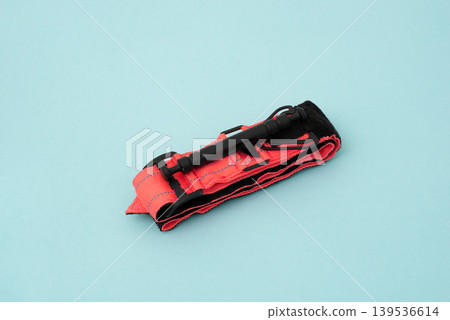 tactical tourniquet for emergency medical first aid and bleeding control on a blue background tactical tourniquet for emergency medical first aid and bleeding control on a blue background 139536614