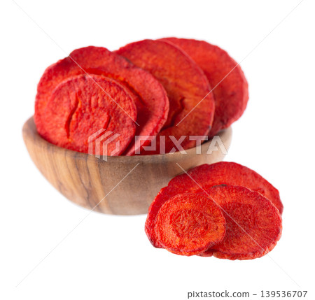 Crispy roasted carrot chips with sea salt, isolated on white background. Healthy and crunchy natural vegetable snack. Clipping path. 139536707