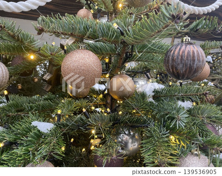 Decorated Christmas tree with ornaments and lights, showcasing festive holiday spirit background 139536905