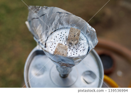 Hookah charcoal on aluminum foil 139536994