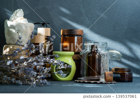 Scented candles and jars with essential oil. Dried lavender flowers. Aromatherapy Scented candles and jars with essential oil. Dried lavender flowers. Aromatherapy 139537061