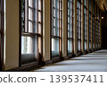 A long, narrow row of windows in a retro corridor, letting in plenty of light. 139537411