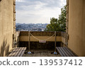 A bench and chain on a terrace overlooking the cityscape 139537412