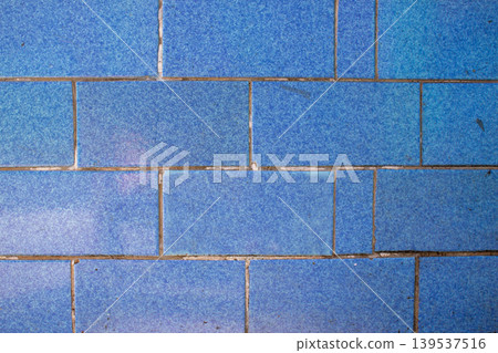 Blue ceramic tile with marble spotted motif in a horizontal pattern. 139537516