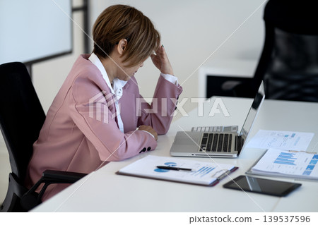 Senior businesswoman is stressed and thinking while working 139537596