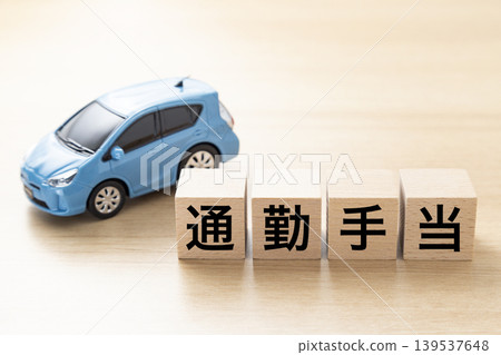 A block with "Commuting Allowance" written on it and an eco-car A block with "Commuting Allowance" written on it and an eco-car 139537648