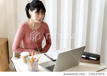 Young teenage woman is communicating or studying Young teenage woman is communicating or studying 139537679
