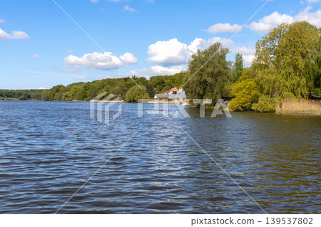 Blue lake water and peaceful nature landscape under clear sky in Denmark. Blue lake water and peaceful nature landscape under clear sky in Denmark. 139537802
