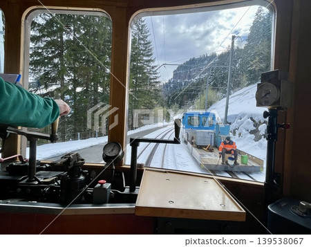 [Switzerland] Snow-covered mountains and work vehicles viewed from the window of the Rigi Railway train. 139538067
