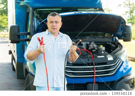 Driver ready to jump start truck battery on road 139538118