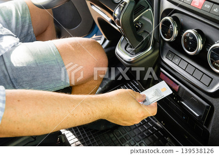 Close up of hand with tachograph driver card Close up of hand with tachograph driver card 139538126