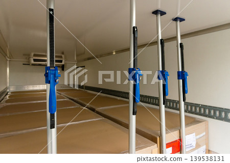 Cargo shoring bars inside truck trailer for load security Cargo shoring bars inside truck trailer for load security 139538131