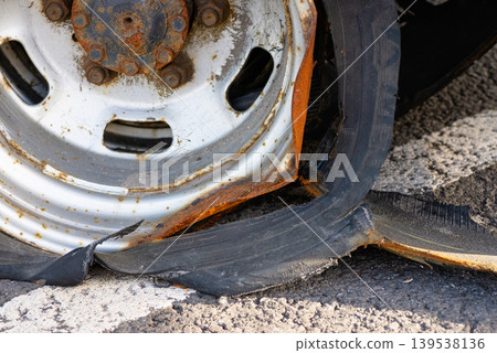 Close up of punctured and damaged truck tire rubber 139538136