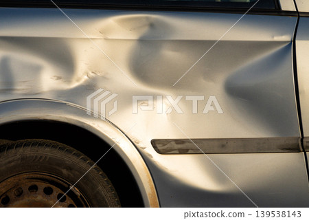 Damaged car body metal panel with deep dent Damaged car body metal panel with deep dent 139538143