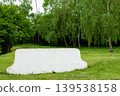 White concrete bench on green grass in park 139538158