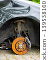 Rusty brake disc on damaged car without wheel 139538160