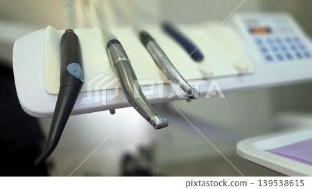 Closeup dental handpiece and instrument tray for clinic equipment background and procedure detail banner Closeup dental handpiece and instrument tray for clinic equipment background and procedure detail banner 139538615