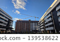 Construction site between residential buildings with tower crane for urban development background and real estate banner design 139538622
