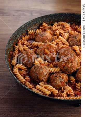 minced meat meatballs, in tomato sauce, with fusilli pasta, in a cast-iron pan, homemade, no people, minced meat meatballs, in tomato sauce, with fusilli pasta, in a cast-iron pan, homemade, no people, 139538649
